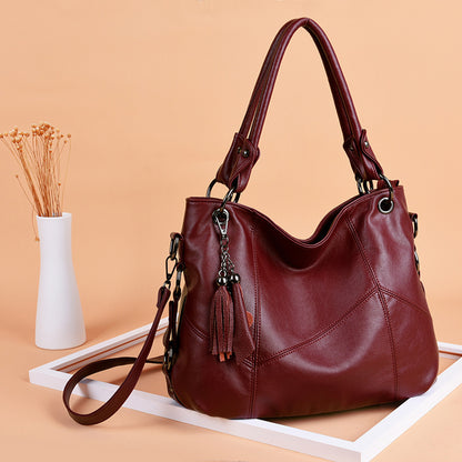 Wine red tassel bucket crossbody bag swinging on shoulder European retro style daily wear