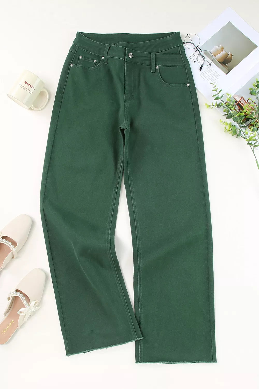 Pocket detail on cotton-rich denim jeans with crossed waistband styling