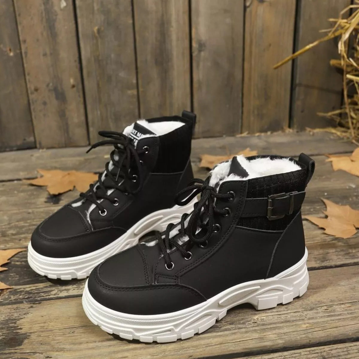 Women's warm winter lace up boots in tan color styled with black leggings and coat