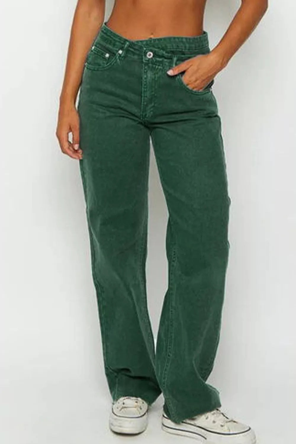 Side angle of crossover waist jeans showing the defined waistband and clean raw hem finish