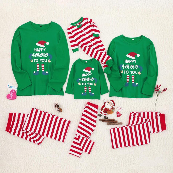 "christmas pjs for family soft green doll print loungewear for parents kids and teens baking cookies in warm kitchen scene"