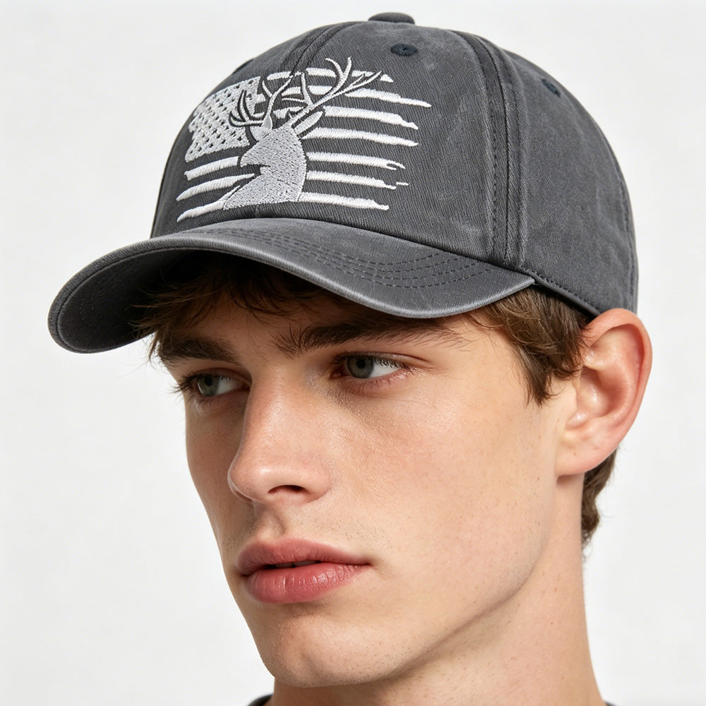 Gray cap with a white design worn by a person on a light gray background