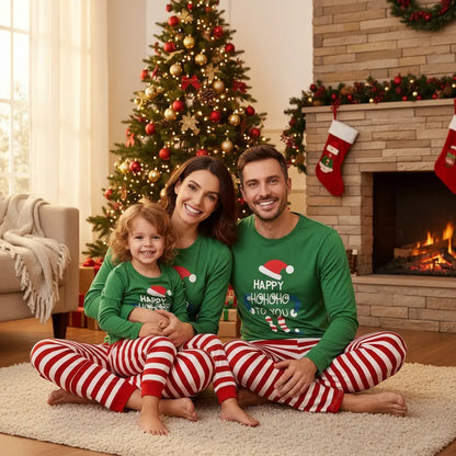 "family christmas pajamas cotton knit doll print in festive green for coordinated holiday card photos on couch with presents"