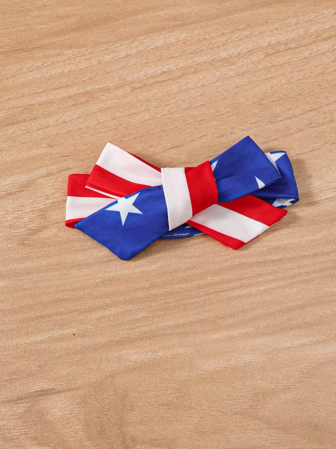4th of July baby headband bow wide fabric bow in stars and stripes pattern for matching festive baby outfit
