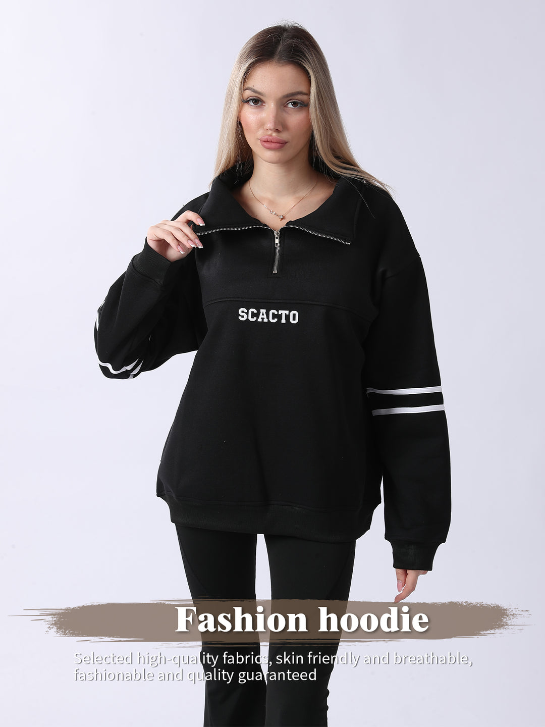 Woman wearing a black hoodie with &