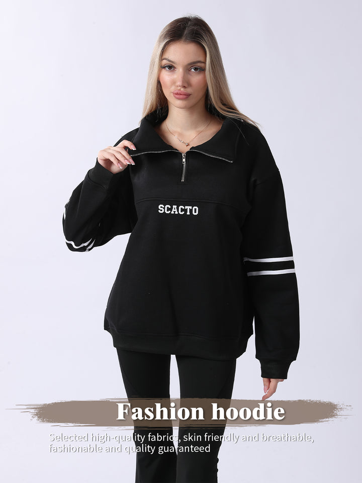 Woman wearing a black hoodie with &
