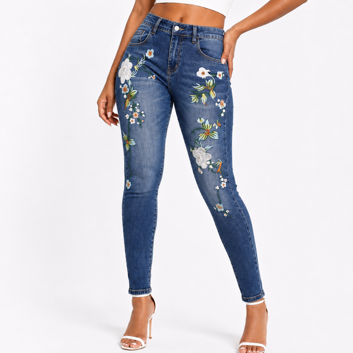 Full length skinny embroidered jeans in blue denim with slim pencil pants fit, flower pattern details, and urban outfit style
