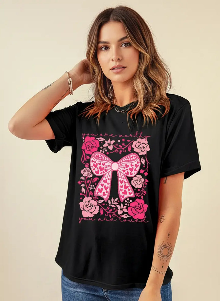 Valentines day shirt women in white with dainty flowers and bow artwork, tucked into high waisted jeans and layered necklace