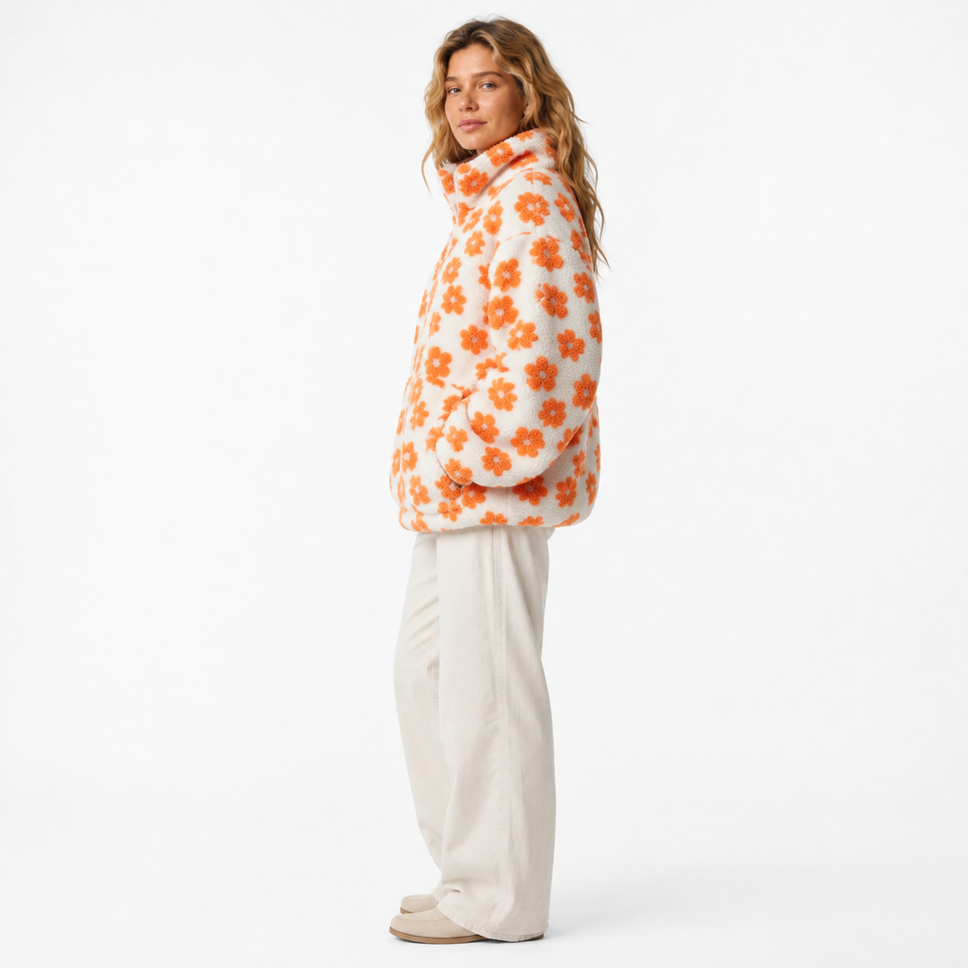 Half-zip sherpa fleece pullover showing floral pattern, lapel-style collar, oversized sleeves and one practical large pocket.
