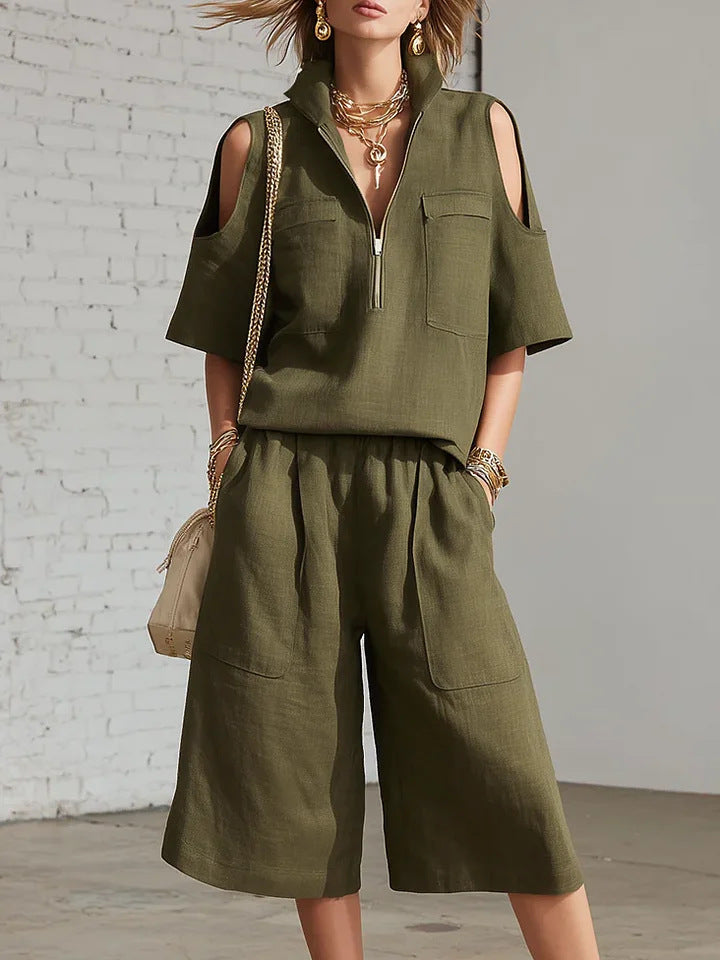 Flat-lay top and pants arranged neatly, showcasing the clean color match across both pieces 