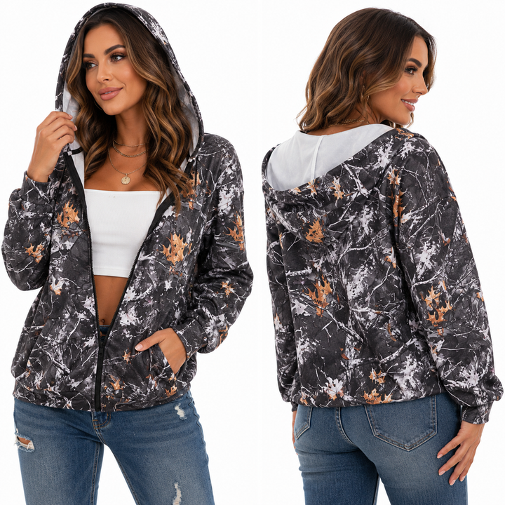 Women vintage zip-up hoodie with camo leaf print, zipper front, pockets, and relaxed streetwear fit on white background.