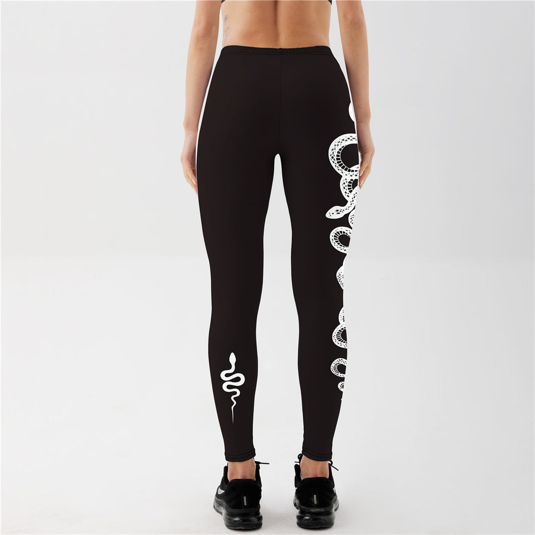 "Serpent graphic yoga leggings with crescent moon motif, black performance fabric for flexible training and yoga flows"