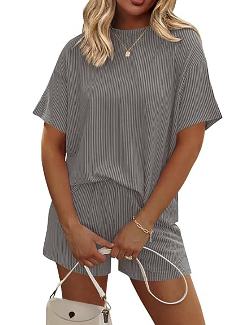 Woman wearing a gray striped outfit with a white background