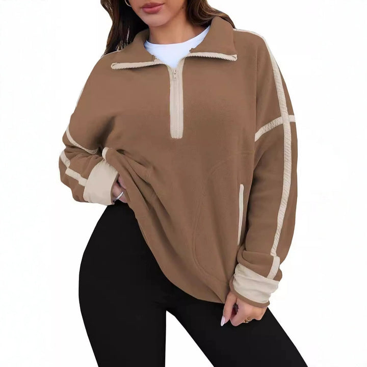 Brown pullover with white accents worn by a person on a white background