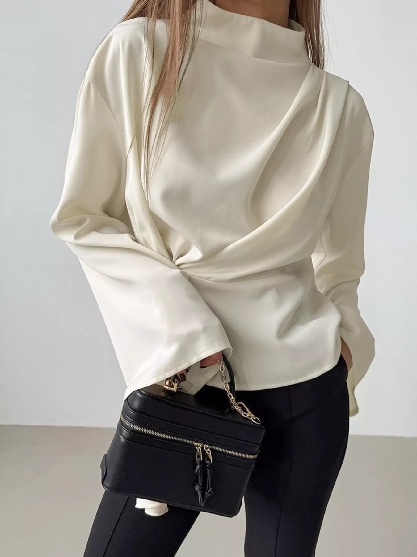 Ruched mock neck blouse zipper closure detail at back long sleeve mock neck top on hanger in smooth polyester
