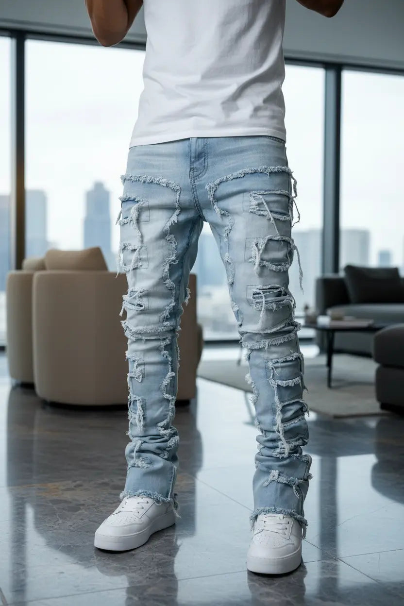 men's stacked jeans side profile highlighting stacked ankle and ripped thigh panels in light blue denim
