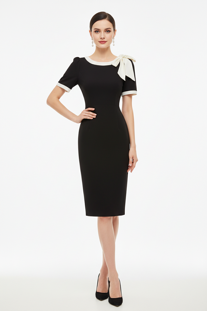 Crew neck slim dress flat lay showing bow color-block design detail
