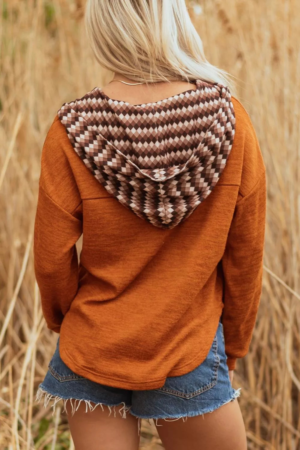 olive green women's hooded henley top styled with jeans