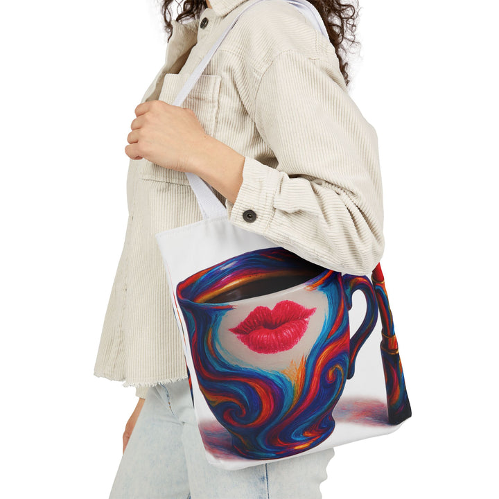 Person holding a colorful tote bag with a design of a face and red lips.