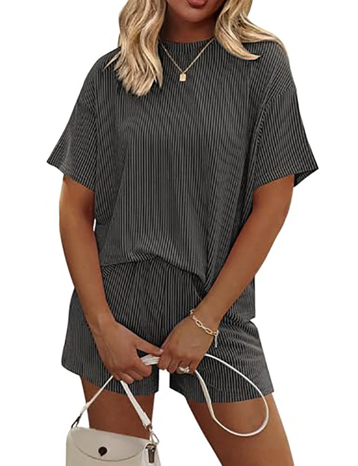 Woman wearing a gray striped outfit with a white background