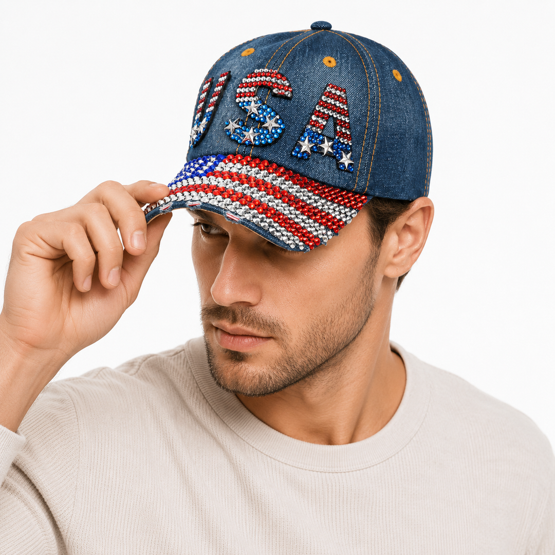 Navy USA baseball cap in washed denim with red, white and blue rhinestones, curved brim and adjustable back closure for fans.
