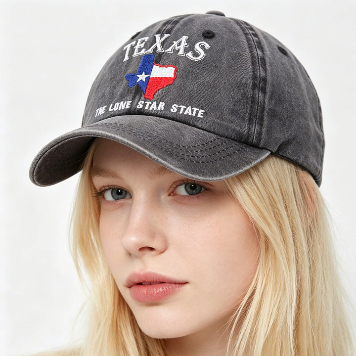 Flat lay of texas baseball cap styled with denim, sunglasses, and travel-ready weekend essentials.