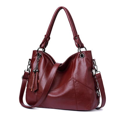 Wine red bucket crossbody bag magnetic snap drawstring closure detail