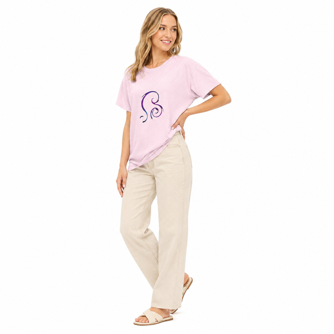 A woman modeling a light pink short-sleeve t-shirt with a purple and blue spiral graphic on the chest, paired with beige wide-leg pants and beige sandals, against a solid white background.