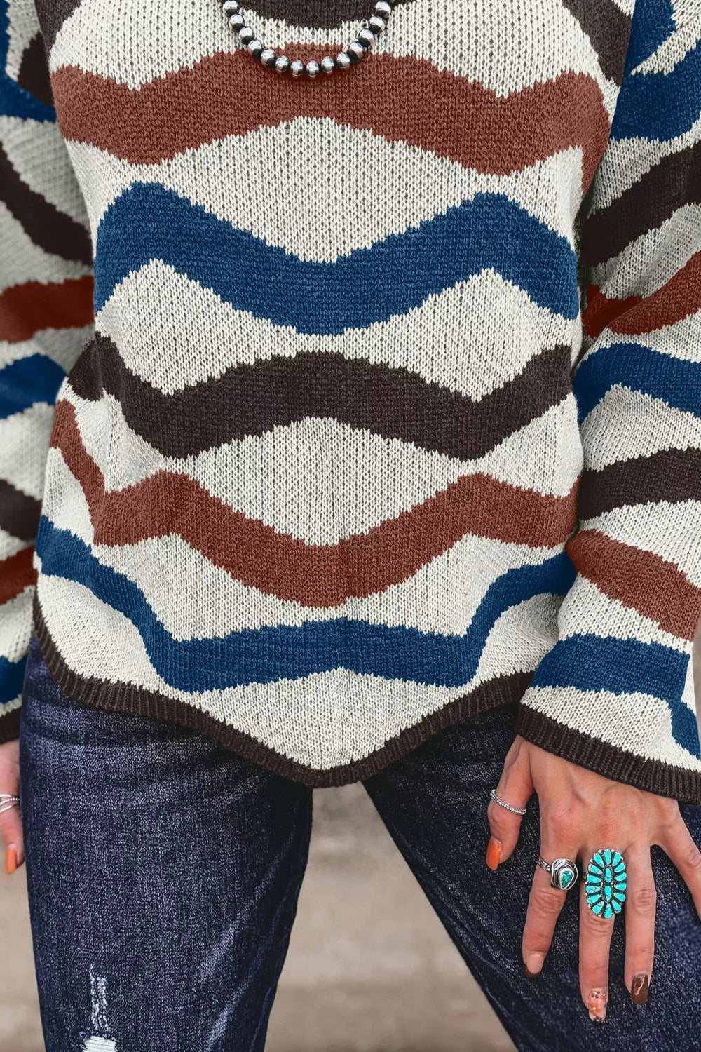 Chevron striped round neck sweater full length laid flat to show top length and stripe layout, crew neck pullover
