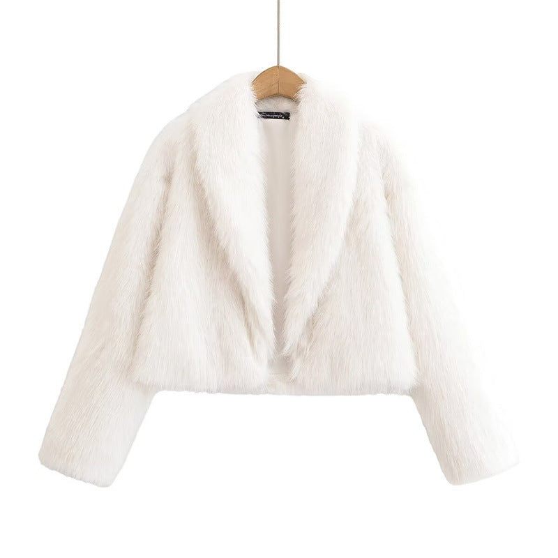 White cropped faux fur jacket on a wooden hanger, showing wide lapels, long sleeves and a straight hem on a white background.