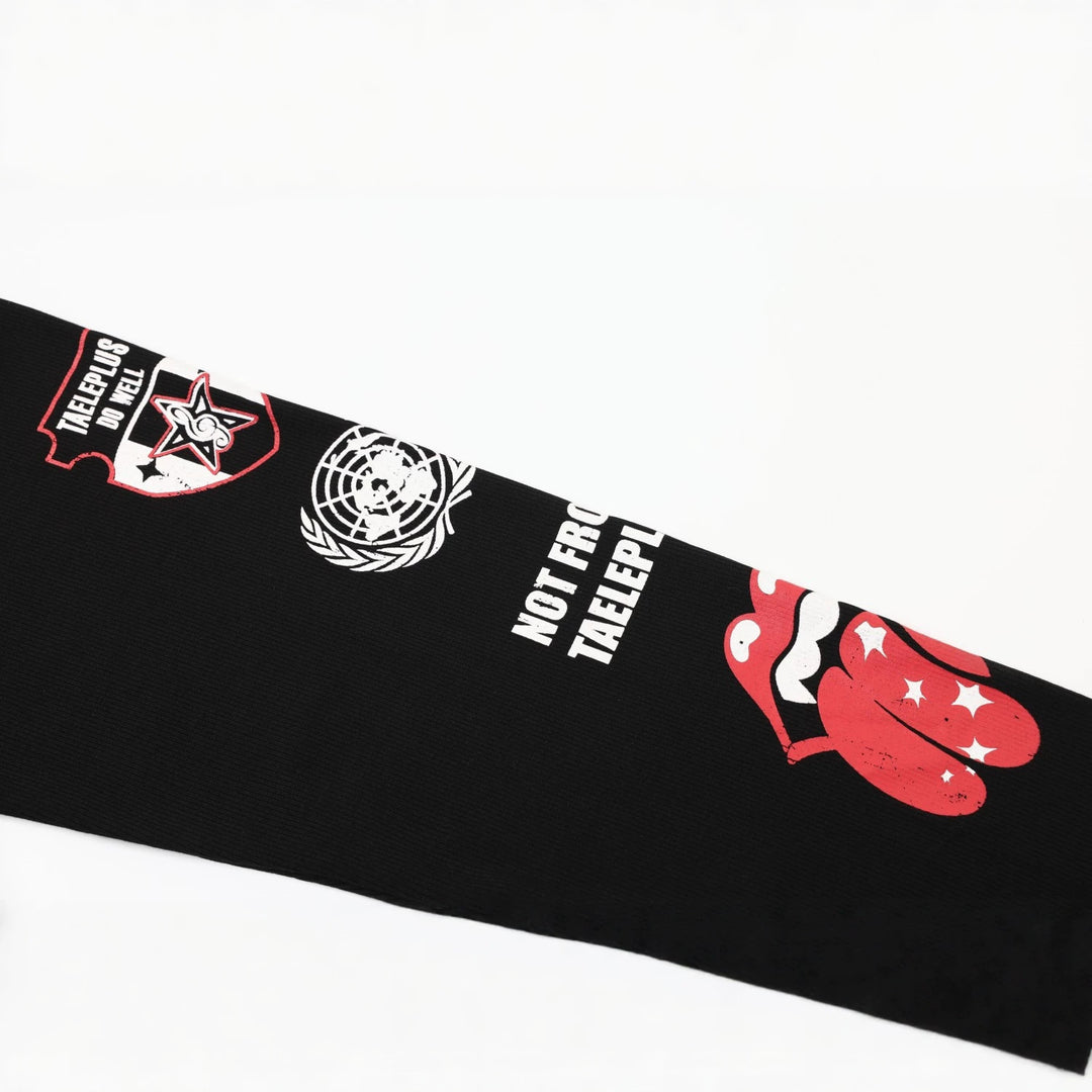 Close-up of the black polo sleeve with the red lips and tongue print, white stars, circular globe artwork and white lettering