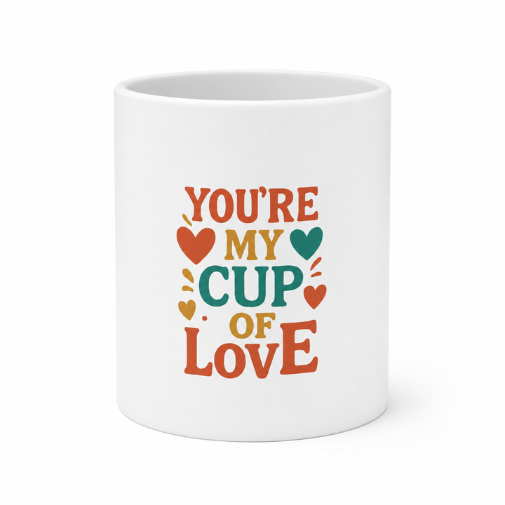Heart shaped mug in white ceramic with a heart handle, bright printed design and glossy finish for coffee or tea gift giving.
