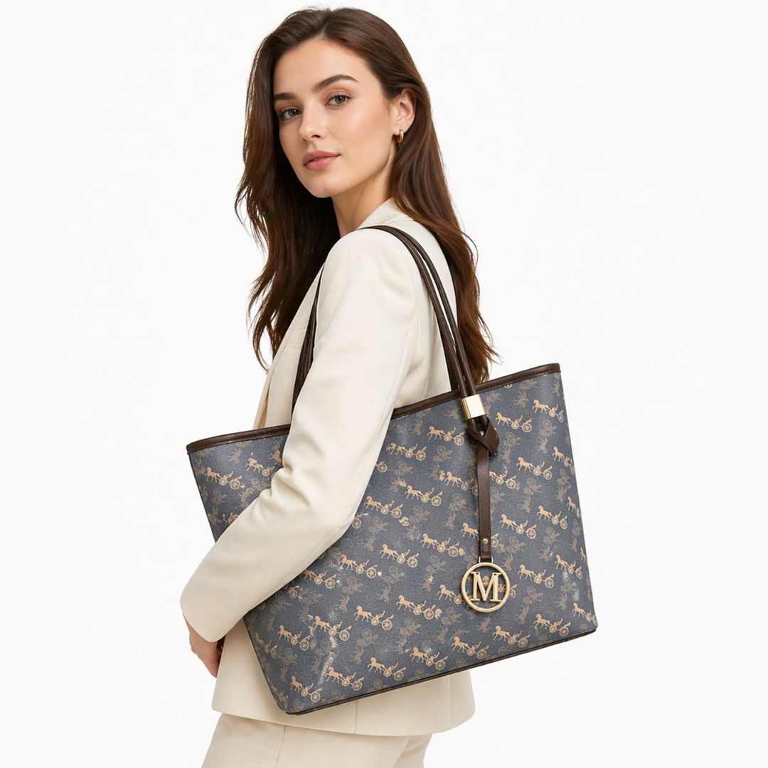 Flat lay of printed tote bag with sunglasses, wallet, phone, and daily essentials.