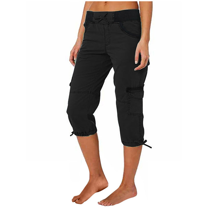 Black capri pants worn by a person on a white background