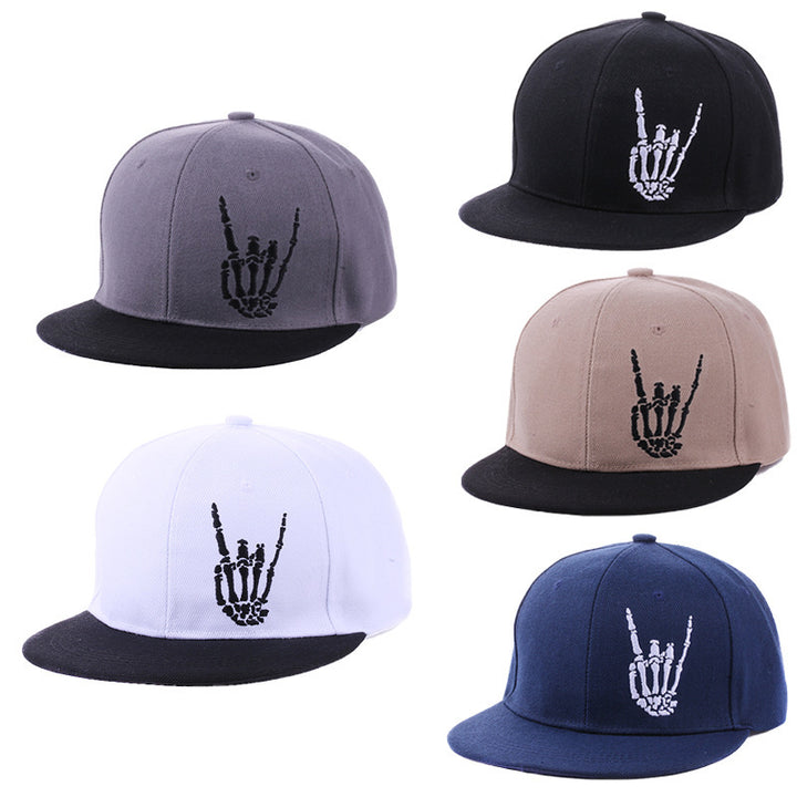 Five caps with skeleton hand designs in different colors on a white background
