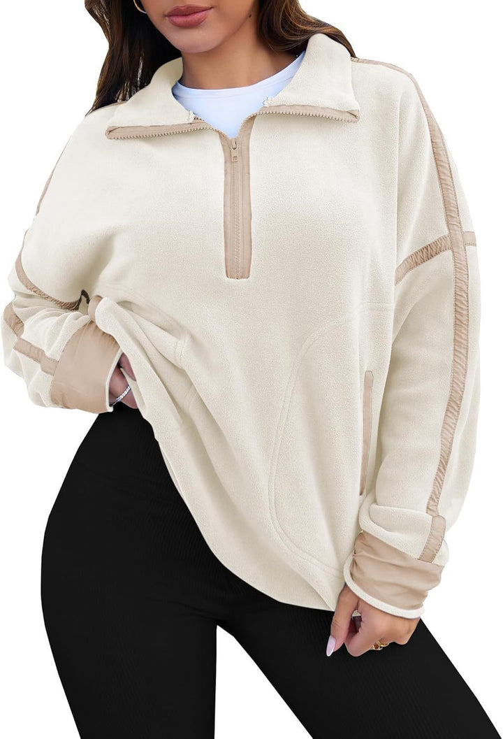Beige fleece pullover with a quarter zip worn by a person on a white background