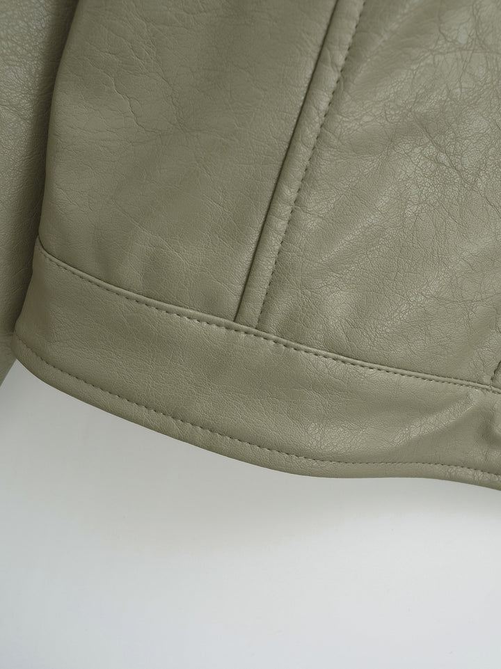 Gray Green jacket hem close-up showing the curved panel seam with a double line of stitching and textured finish as pictured.