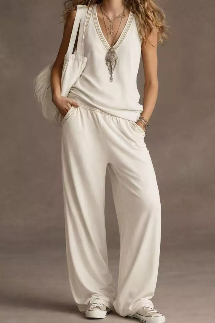 Woman wearing a white outfit with a plain background
