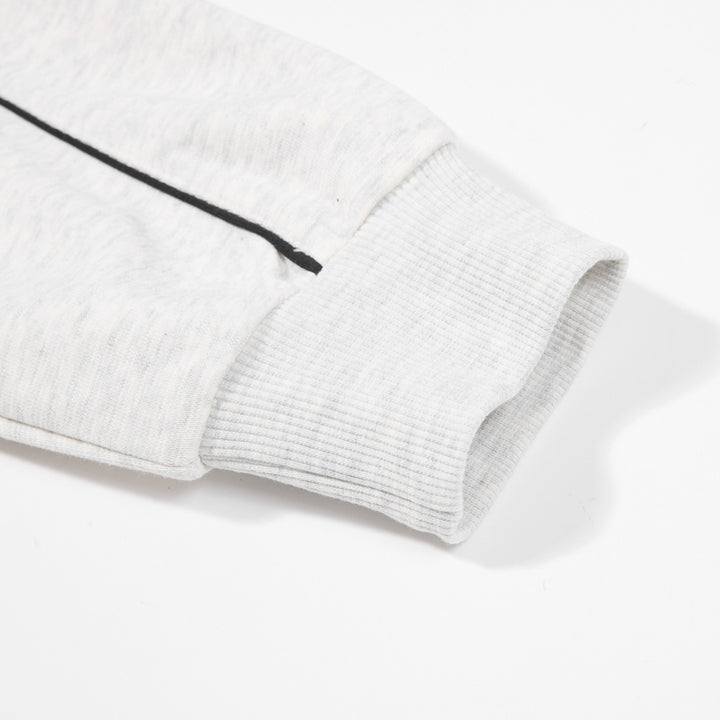 Close-up of the Modern Gray pullover sleeve showing dark contrast line, ribbed cuff and fabric surface on a white background.