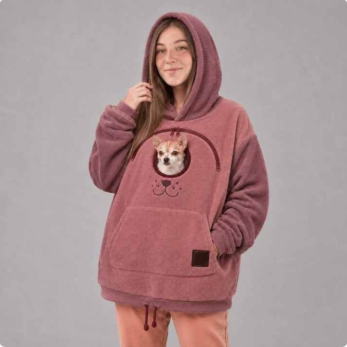 Original image: Woman in a pink hoodie with a small dog in the front opening pictured for comparing the photographed details.