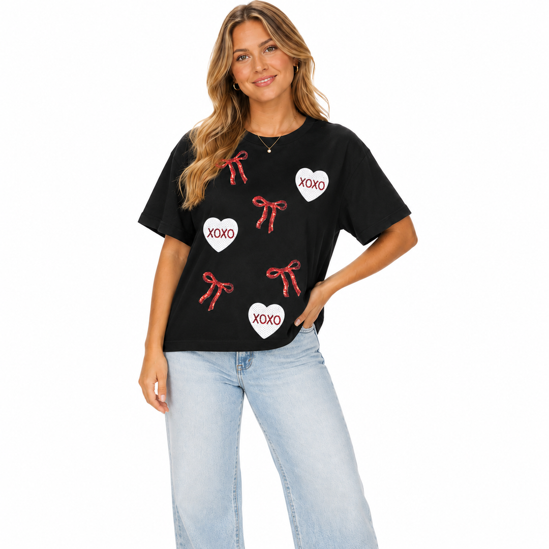 Valentines day shirt for women with XOXO bow, heart sequin patches and loose short sleeve fit for festive outfits now online.
