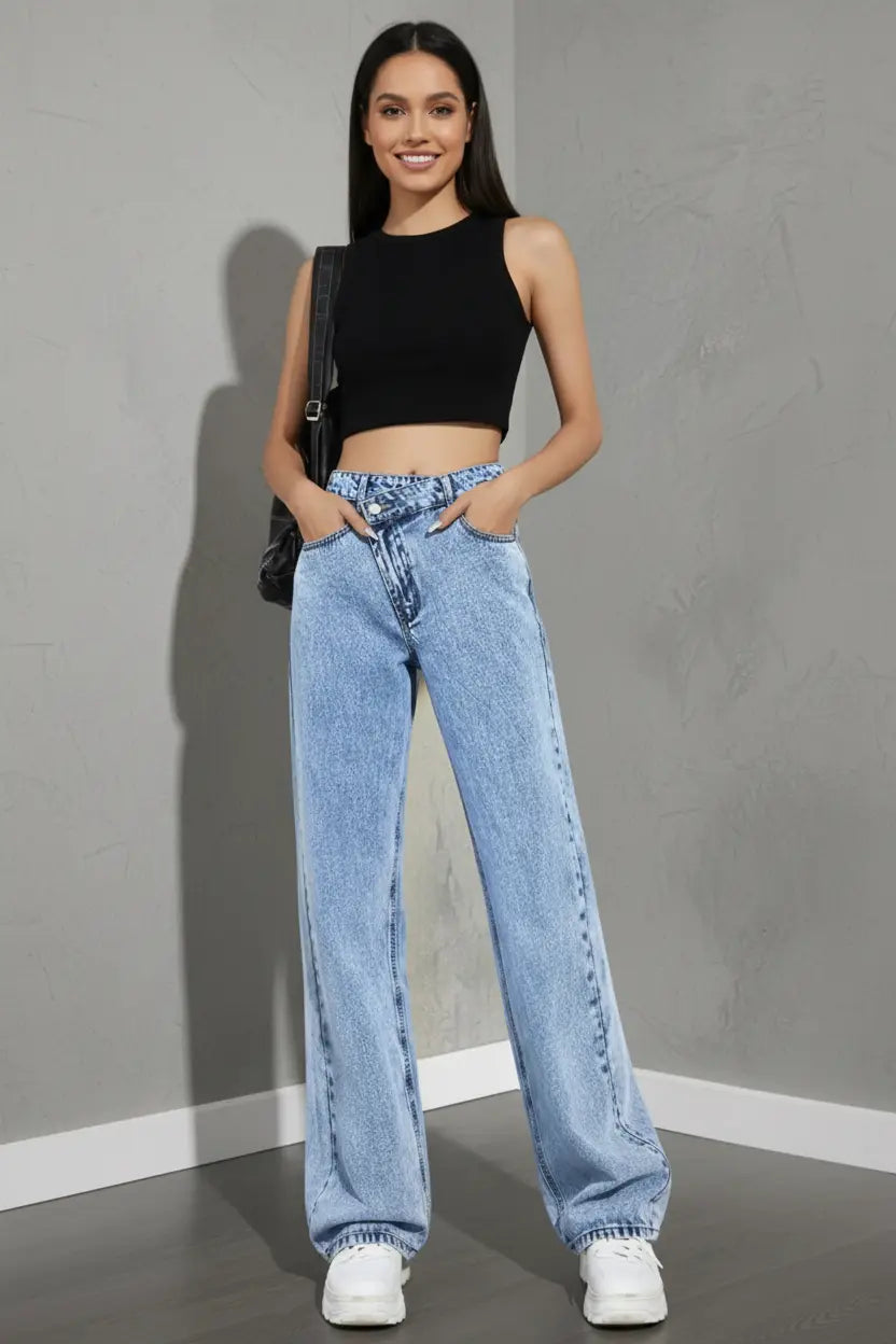 wide leg jeans for women high waist light wash denim relaxed fit side view with long hem pooling over white sneakers
