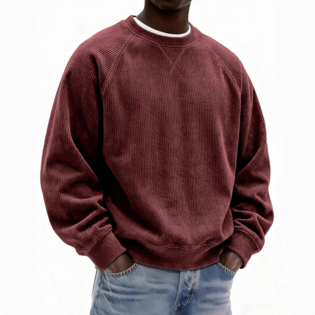 Person wearing a maroon corduroy sweatshirt on a white background