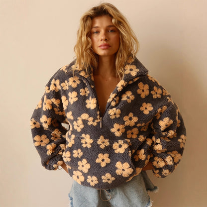 women's sherpa pullover floral print drop shoulder long sleeve cozy teddy fleece styled with denim shorts indoors
