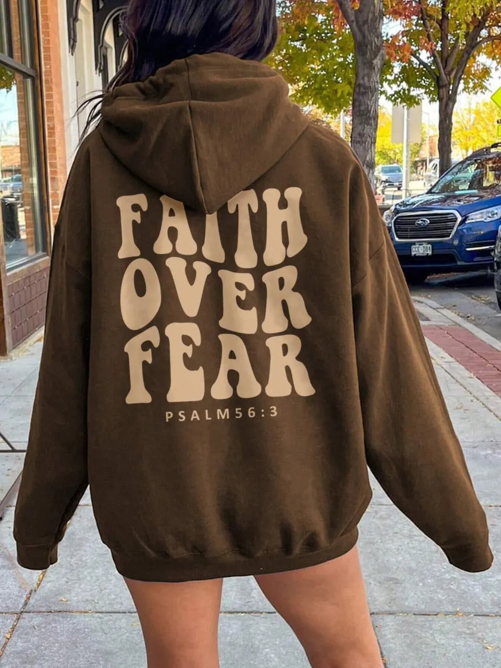 faith over fear hoodie size label and care tag detail machine wash cold tumble dry low for easy maintenance at home

