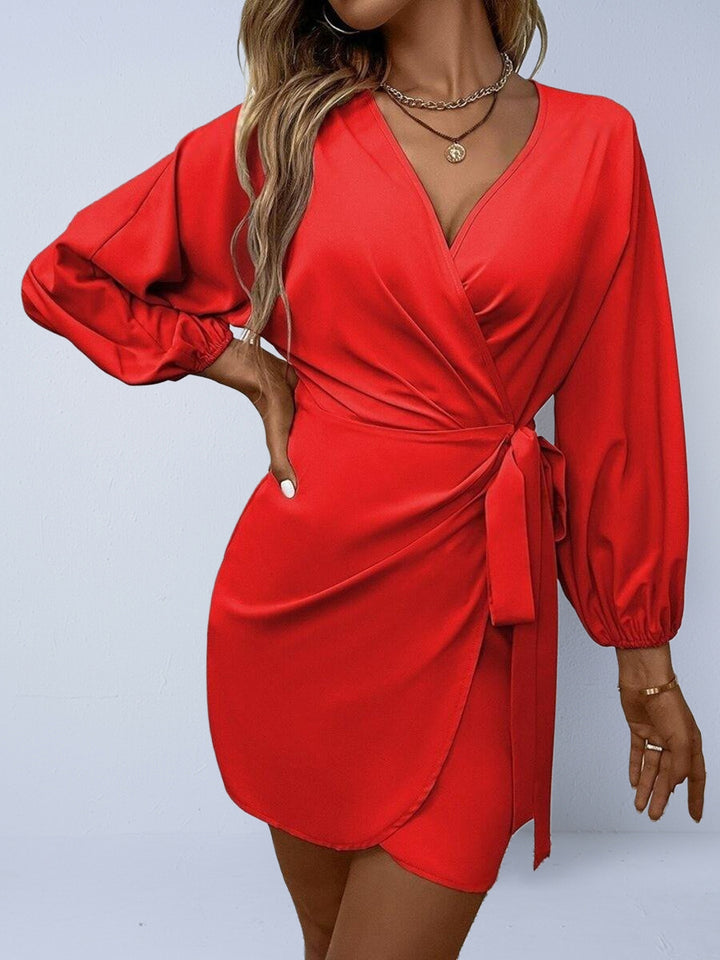 Red wrap dress with long sleeves on a plain background