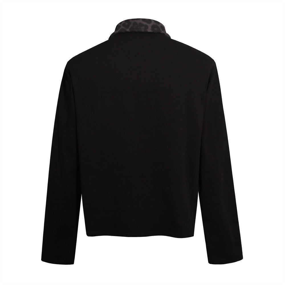 Black long sleeve collared polo shirt shown from the back, with an unprinted body, striped sleeves and dark patterned collar.