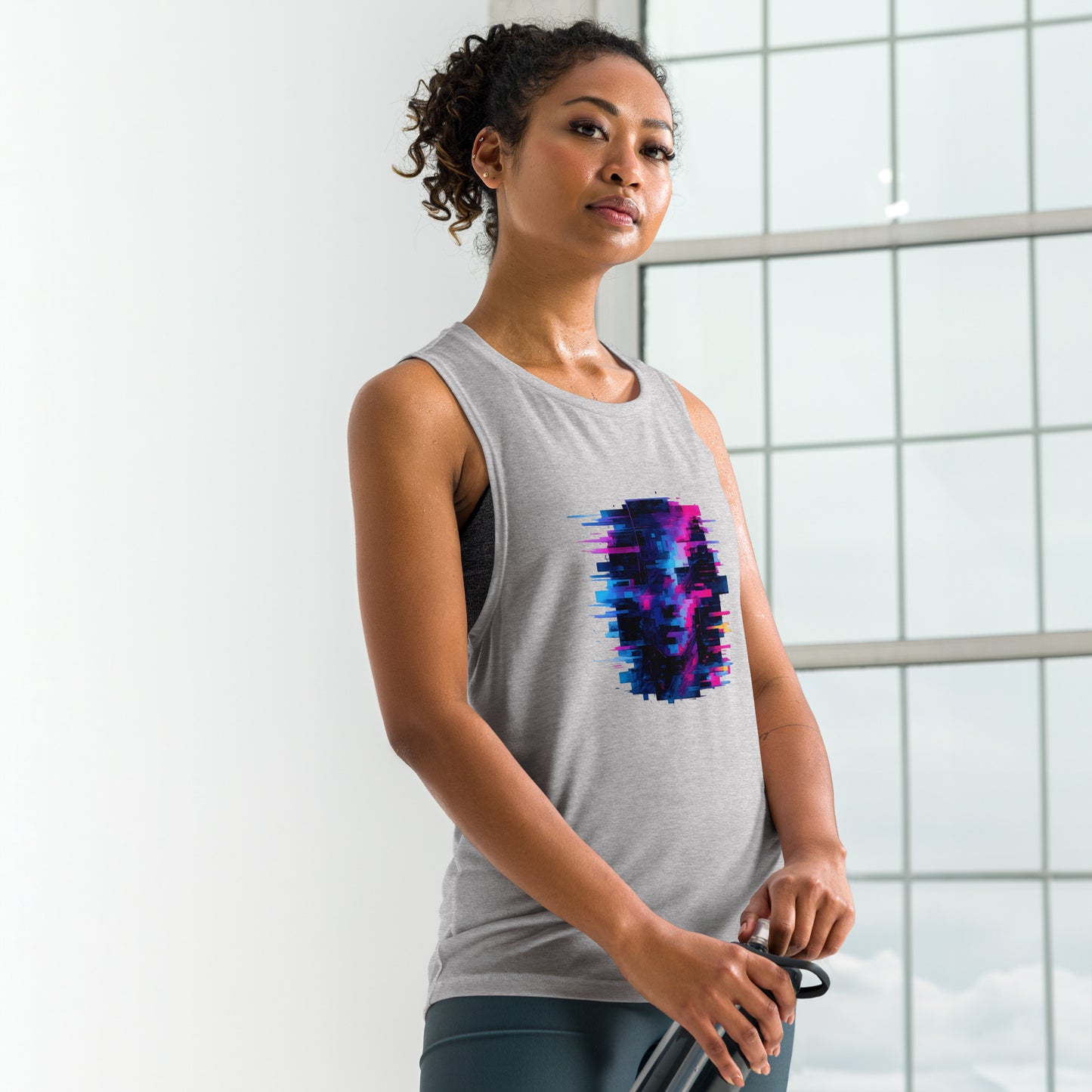 Athletic Heather ladies’ muscle tank during yoga flow, curved hem stays in place through deep stretch.

