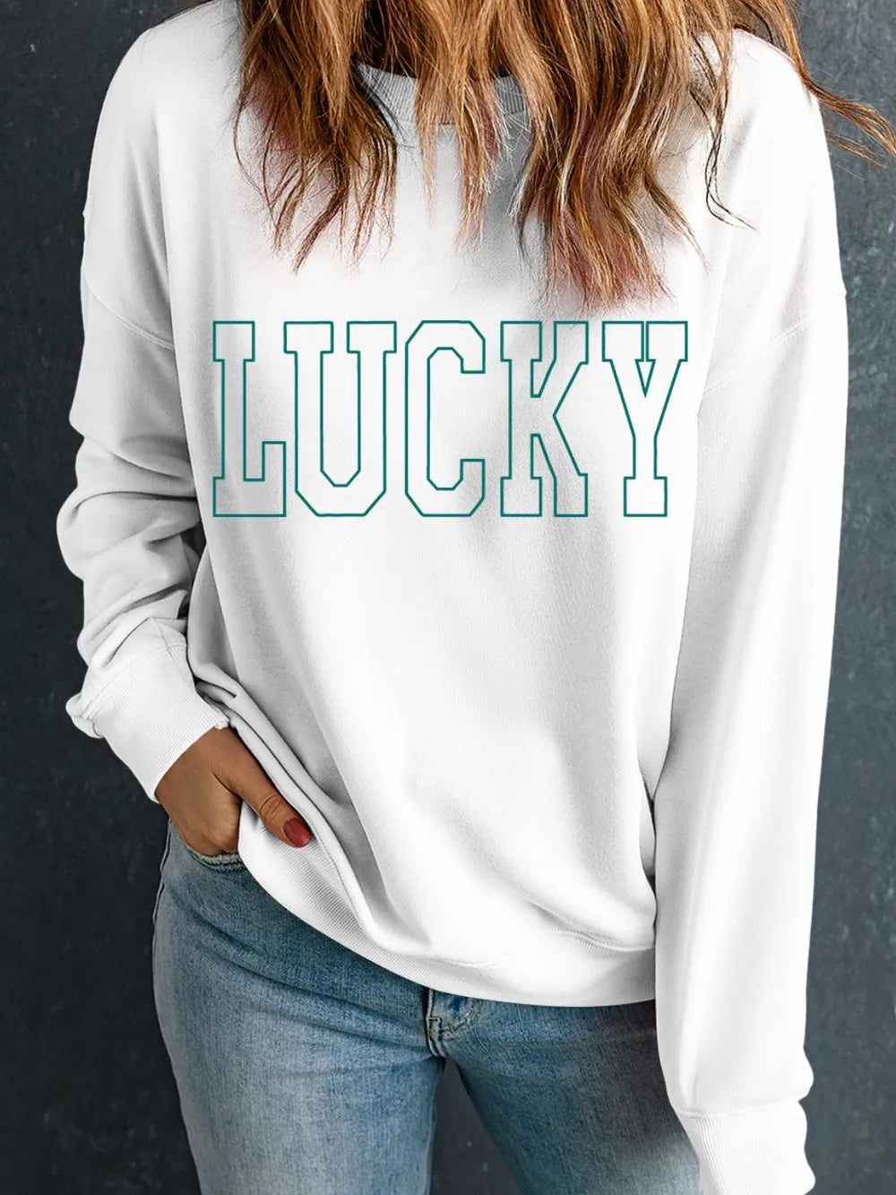 Autumn-themed flat lay with graphic sweatshirt and leaves

