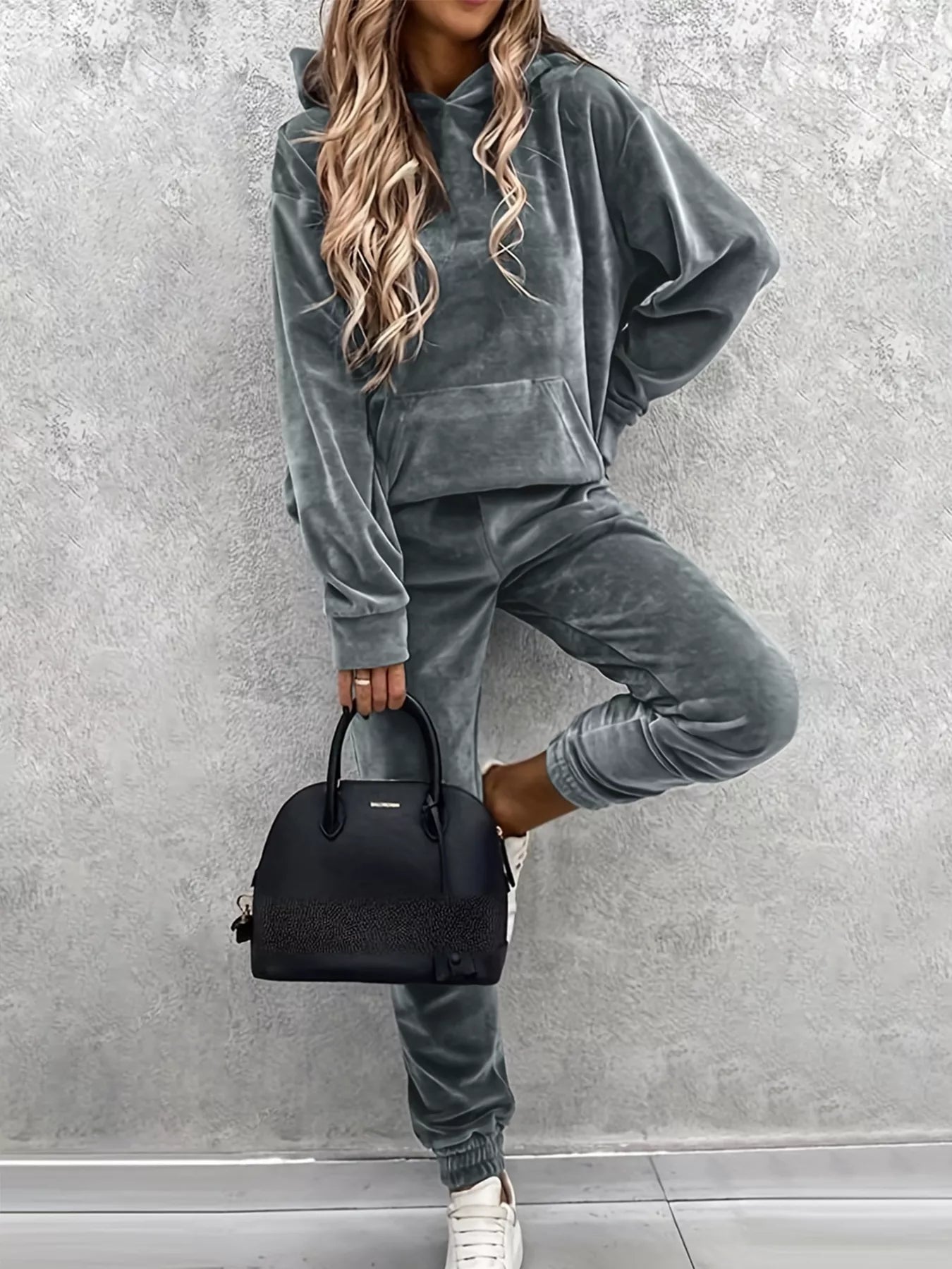 Back view highlights drawstring details in women's kangaroo pocket hoodie pants set, blending comfort with subtle sophistication. 
